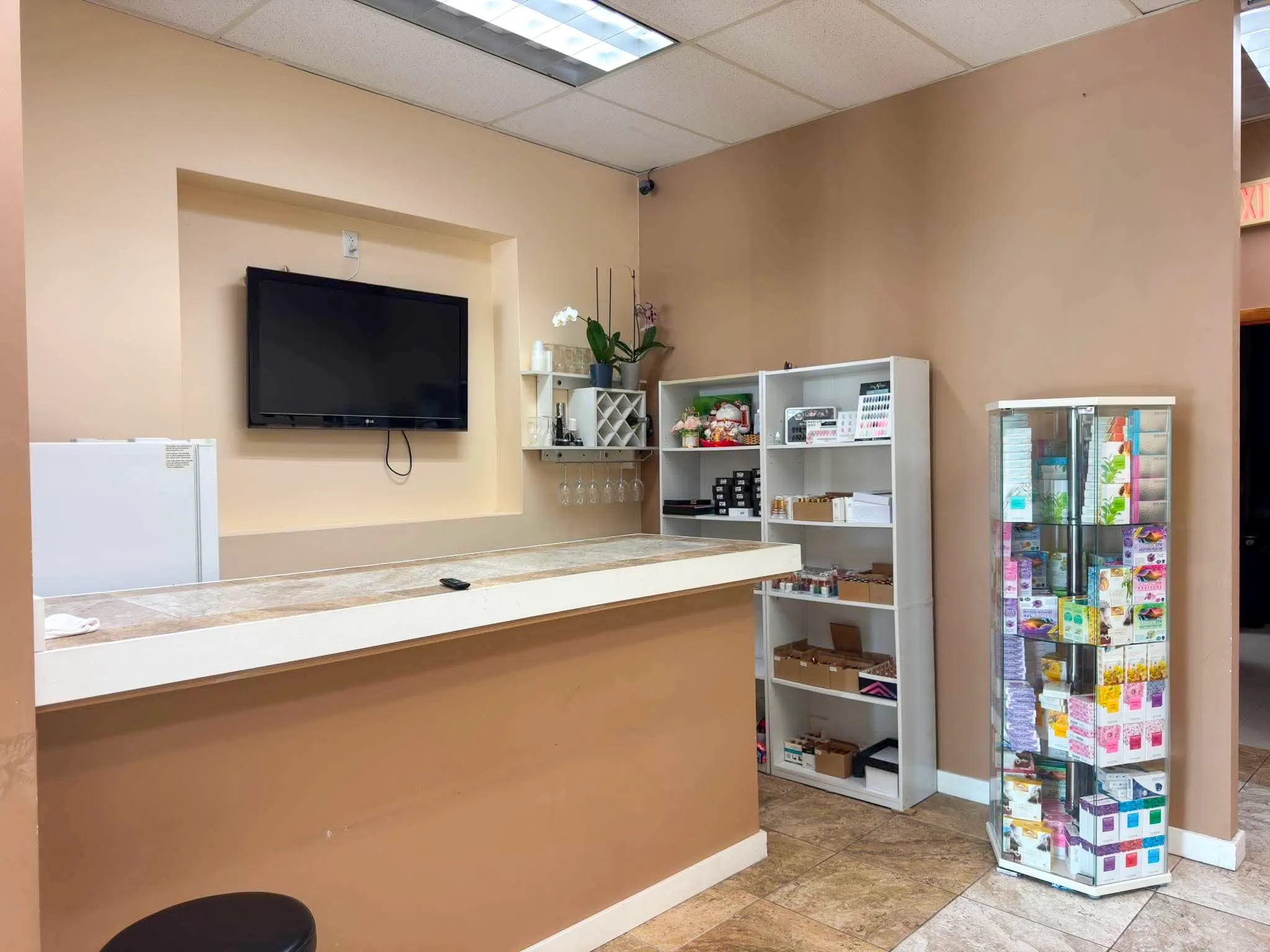 Glamour Nails salon interior in Blasdell, NY — front desk with TV and retail shelves